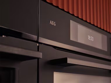 An oven in a red kitchen.
