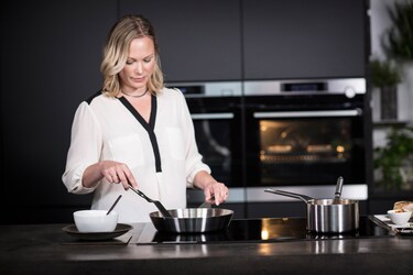 woman cooking on aeg hob
