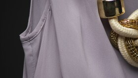 Un top in seta rosa indossato con dei gioielli