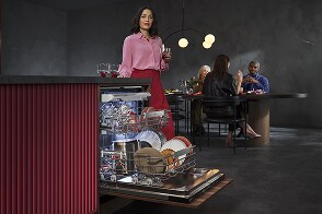 Woman unloading dishwasher